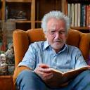 Arthur, an elderly gentleman, comfortably reading a book in his favourite armchair at home.
